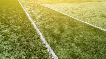 White line on grass green background. Green synthetic grass sports field with white line. Soccer...