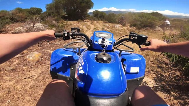 Driving a Quad ATV on off-road in Spain. First-person view on an action camera. Point of view, POV riding ATV bike through the forest. Adventures of off-road on ATVs. 