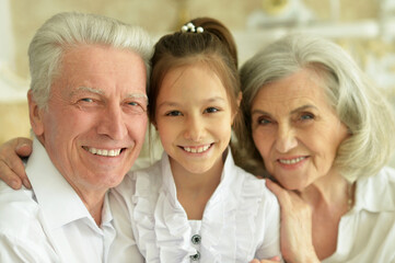 Close up shot of happy senior couple with granddaughter