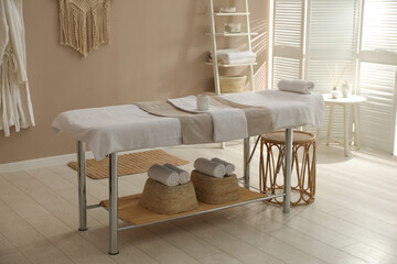Stylish spa salon interior with massage table