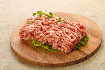 Raw minced pork meat over board