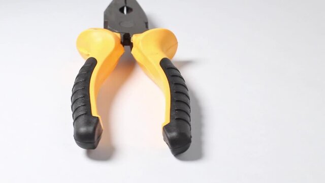 Working tool pliers on a turntable on a white background close up