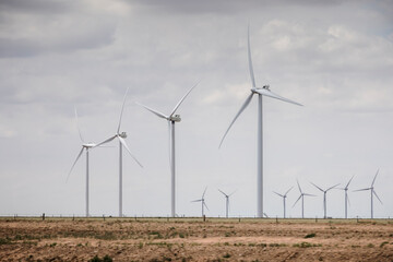 Wind turbines generate electricity near farms in West Texas.