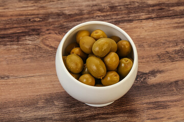 Green pickled olives in the bowl