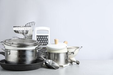 Set of clean kitchenware on light background. Space for text