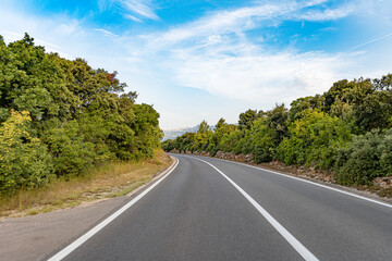 Scenic road. The road is surrounded by a magnificent natural landscape.