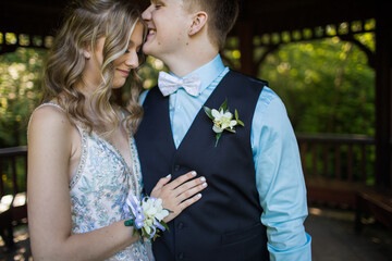 Cute romantic couple touching, kissing under gazebo.