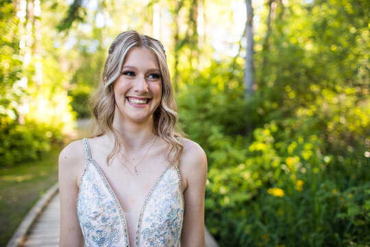 Portrait of a young beautiful blonde woman smiling outdoors.