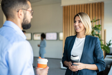 Cheerful colleagues talking during break