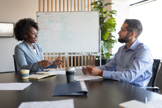 Diverse coworkers talking during conference