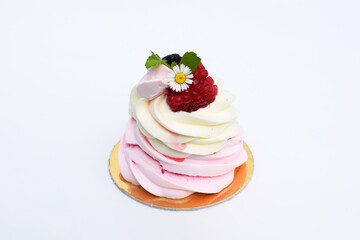 Delicious mini Pavlova meringue cake with berries, leaves of melissa and daisy flower as decoration. Summer romantic dessert