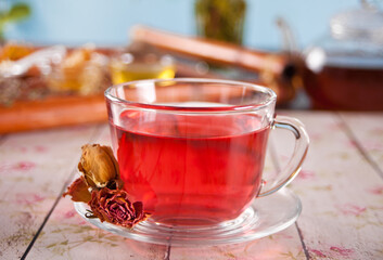 cup of herbal red tea with dry roses hibiscus