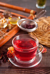 cup of herbal red tea with dry roses hibiscus