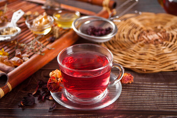 cup of herbal red tea with dry roses hibiscus