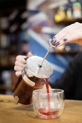 pour red tea from a teapot