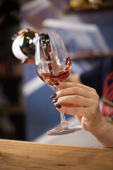 pour red wine into a glass