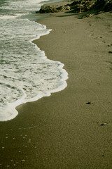 A sinuous ocean wave penetrates the sandy shore. Mojacar Beach, Almeria