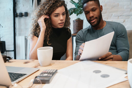 Young couple planning monthly budget together.
