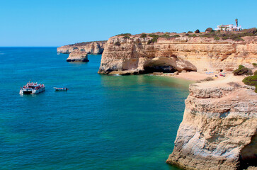 Cliffs, rocks, and beaches in the sunny Algarve coast in southern Portugal, during the summer season