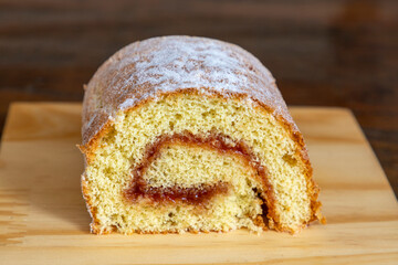 piece of guava roulade on wooden table