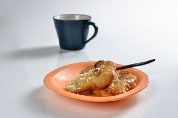 Fried banana in a plate with spoon