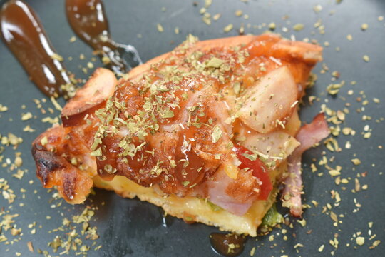 homemade pizza topping pork bacon sausage and cheese dressing mashed dry oregano with kitchup on plate
