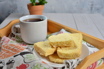 Dry bread on plate and a cup of tea
