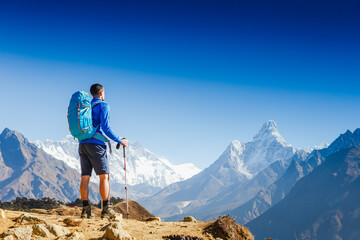 Active hiker hiking, enjoying the view, looking at Himalaya mountains landscape. mountaineering...