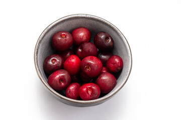 Fresh ripe cherries in a cup on a white background. Vegetarian breakfast. Dessert. Healthy eating.