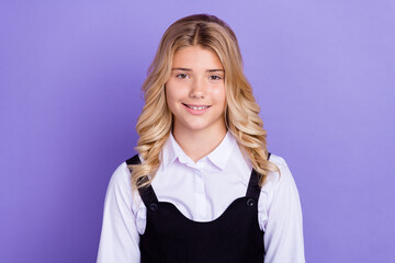 Photo of young happy positive small girl wear school uniform smile good mood isolated on purple color background