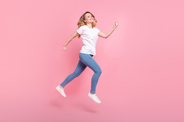 Full body profile side photo happy mature woman jump up air look run empty space isolated on pink color background