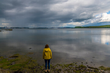 Standing on the shore of the Firth of Forth at Blackness castle, Scotland on a summers day