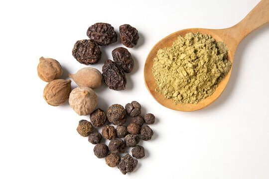 Triphala, a combination of ayurvedic fruits and Triphala powder on white background. Herb concept.
