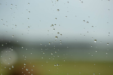 Raindrops on the glass at beautiful gentle nature gradient colors.