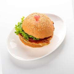 burger with chicken on a white plate