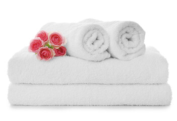 Obraz na płótnie Canvas Fresh clean towels with roses on white background