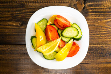 salad fresh vegetables cut into pieces on a white plate