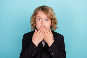 Photo of voiceless small blond boy close mouth wear uniform isolated on blue color background