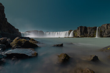 Long exposure photo of magnificent Godafoss waterfall in northern Iceland on a warm summer day. Visible flow of water coming from the waterfall.