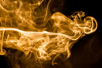 Golden smoke on black background.