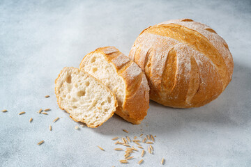 Loaf of round wheat bread with slices. Homemade baking.