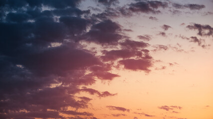 Magenta dramatic sunset sky as background. Fluffy illuminated clouds making atmospheric mood