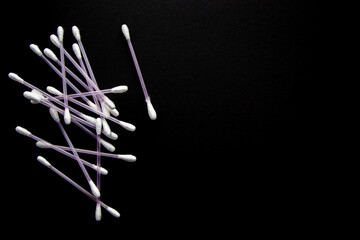a lot of cotton buds on black background