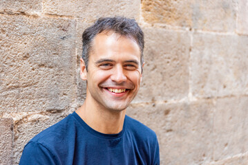 Close up portrait of smiling latin man with heterochromia