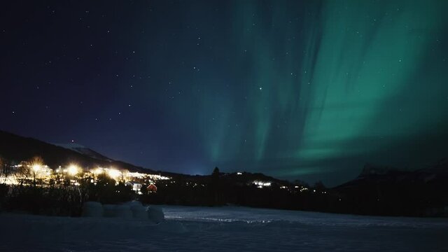 A beautiful view of green northern lights at night in Volda, Norway