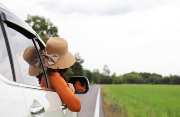 Closeup of woman driver in white car parking on local road with natural background. during lovely...