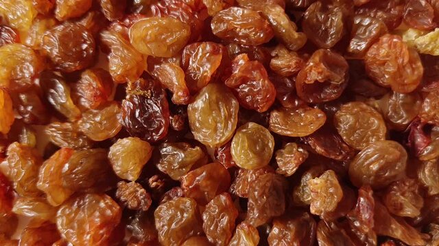 Dry golden brown sweet raisins close up top view. Macro food us a background with copy space from above. Nutrition vegan vegetarian snack ingredient concept
