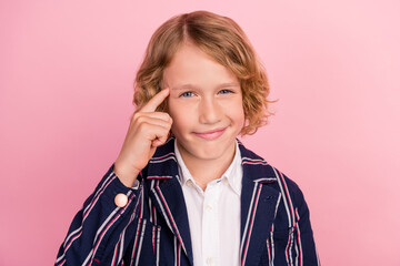 Photo of young small boy finger touch head think memory accuse tease stupid isolated over pink...