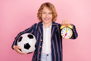 Photo of young school boy happy positive smile hold soccer ball watch timer match isolated over pink color background