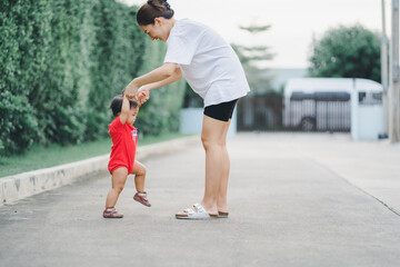 baby step in outdoor to practice balance walk in development according to the age of the child with...